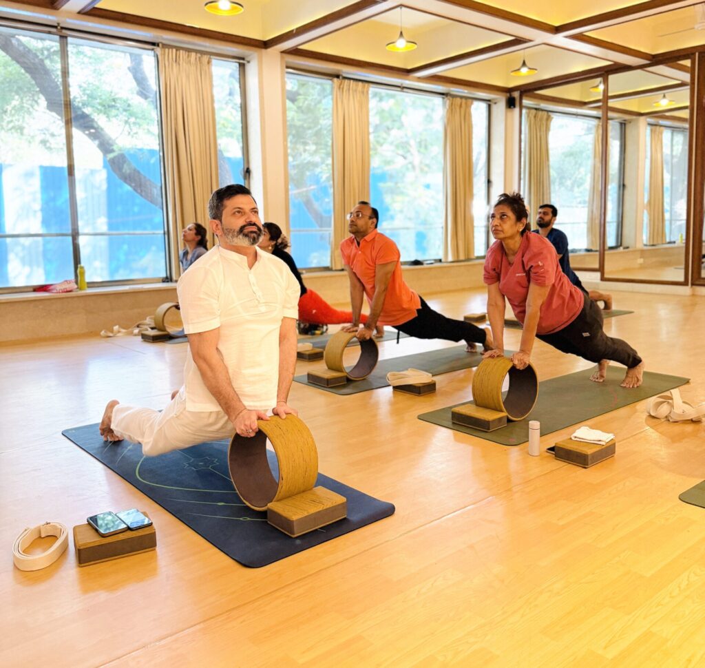 Yoga teacher in Juhu Mumbai guiding students through breathing exercises